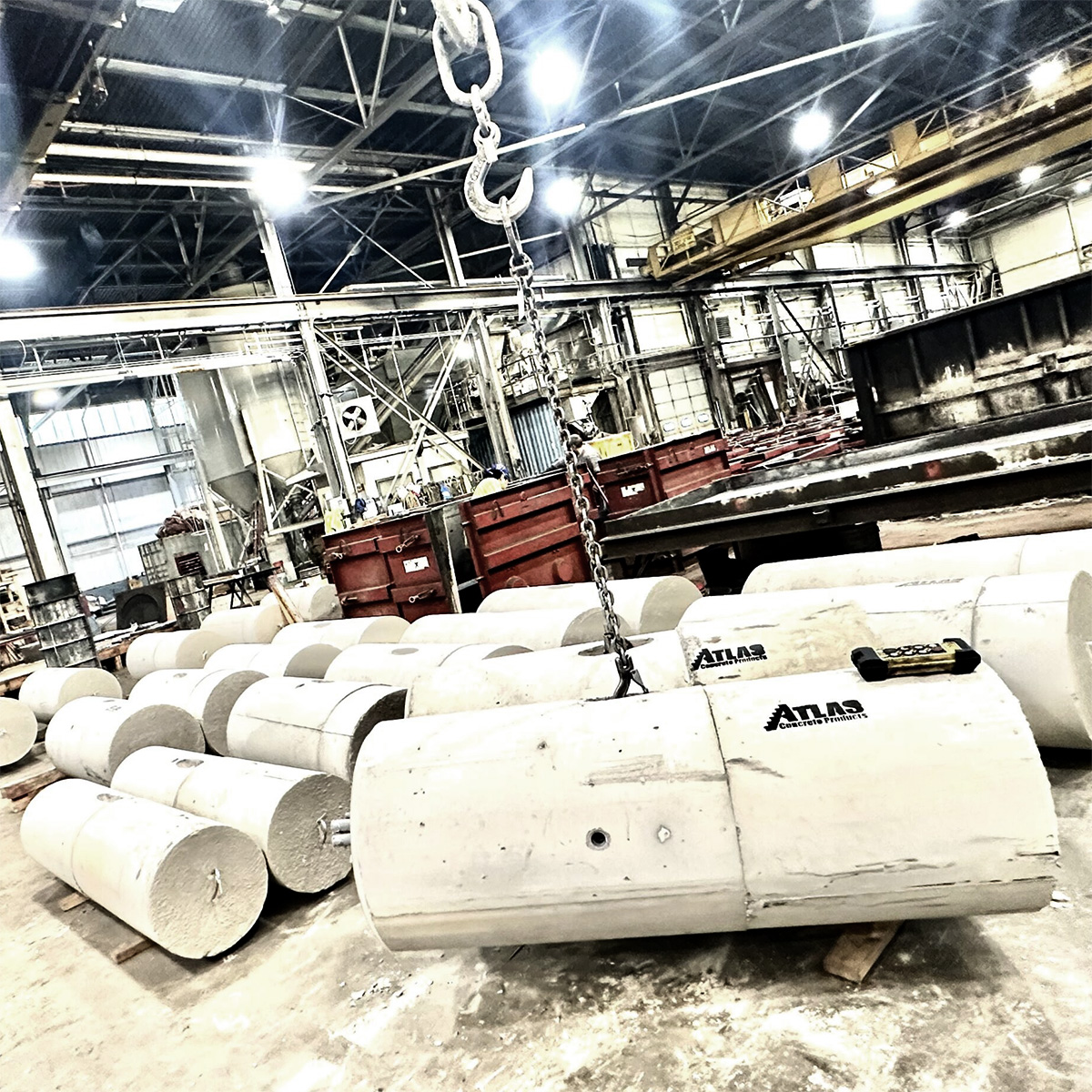 Atlas Concrete Products Inc manufacturing high-strength 5000 PSI round precast light pole bases for Windsor Locks CT commercial parking lots.
